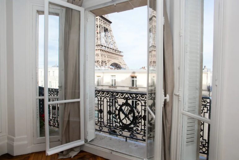 Giant picture windows with views of the Eiffel Tower