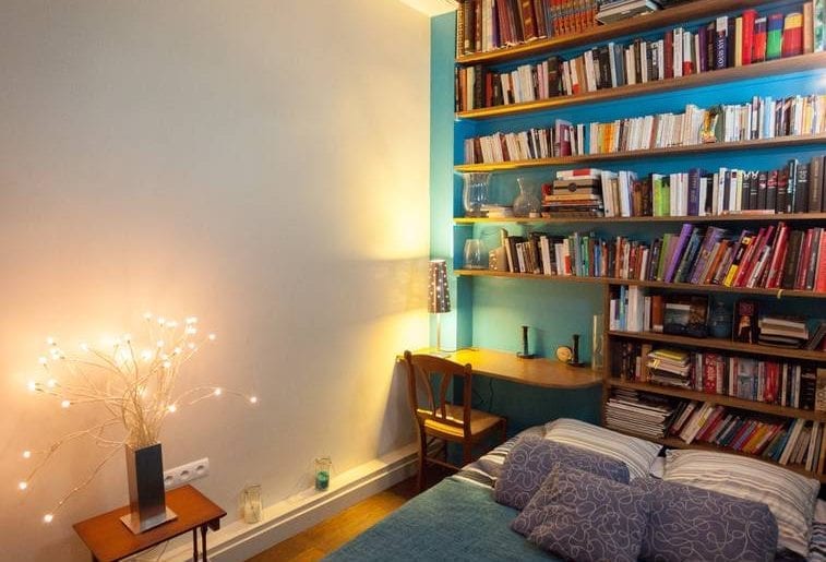 Cozy bedroom with extensive bookshelf