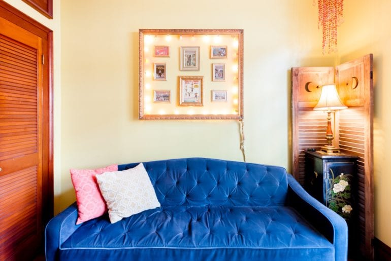 The vibrant blue couch is a cozy place to relax after a long day of exploration 