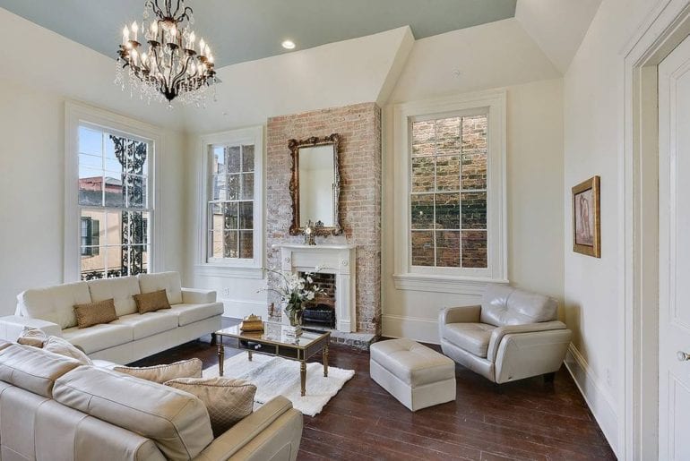 Floor to ceiling windows that open to a Balcony on Bourbon Street where you will admire the architect of the French Quarter.