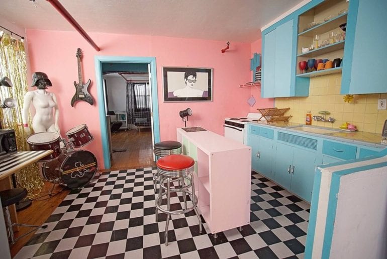 This retro kitchen is a set for a cooking series, complete with drums and Darth Vader helmet. Miami on the cheap.