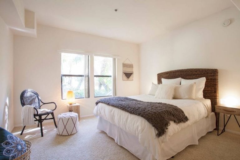 This bright and spacious bedroom has an inviting atmosphere and cozy features. 