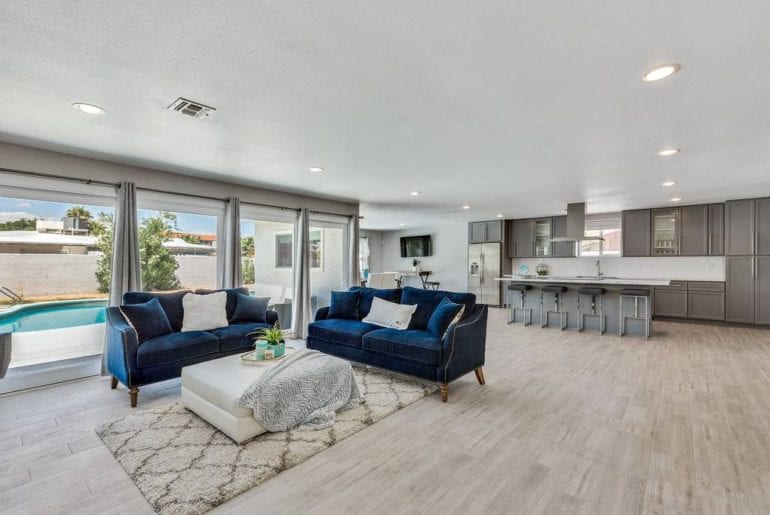 Floor-to-ceiling windows brings the outdoors in and transforms this living room into a bright and airy retreat.