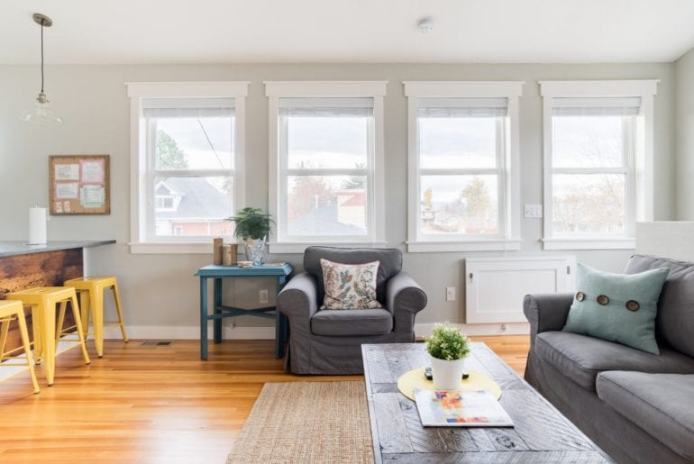 This living room has giant windows - giving the space a bright and energizing vibe