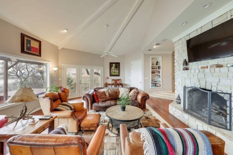 The living room has a fireplace, 70” television, and plenty of seating for the whole family