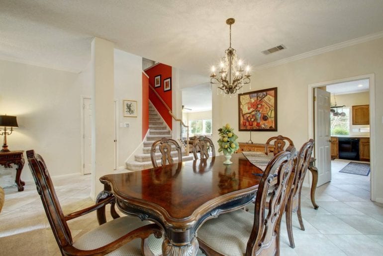 This is one of the three dining areas in this large home, with a full dining room set and chandelier 