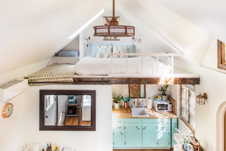 The space in this tiny home is utilized creatively with a loft style bedroom.