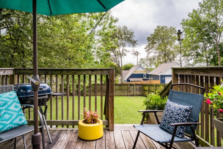 The outdoor space is perfectly groomed and is complete with a BBQ grill and outdoor seating