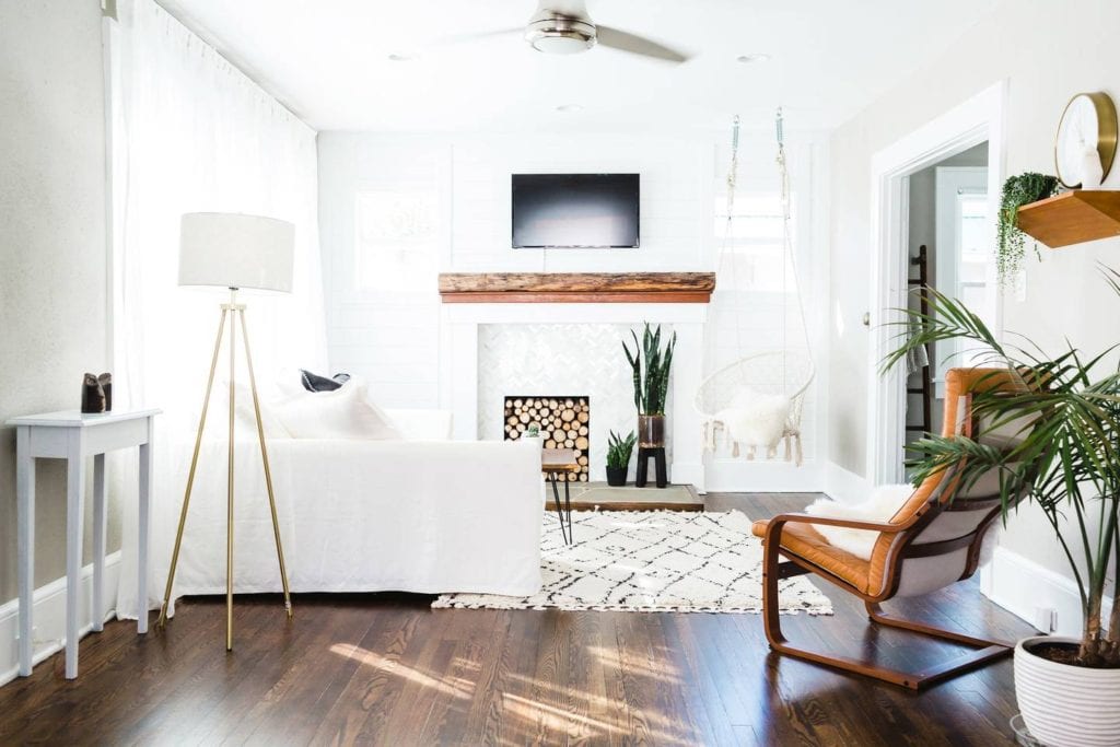 Bright, chic home featuring boho vibes, modern decorations, and a netted swing in the living room