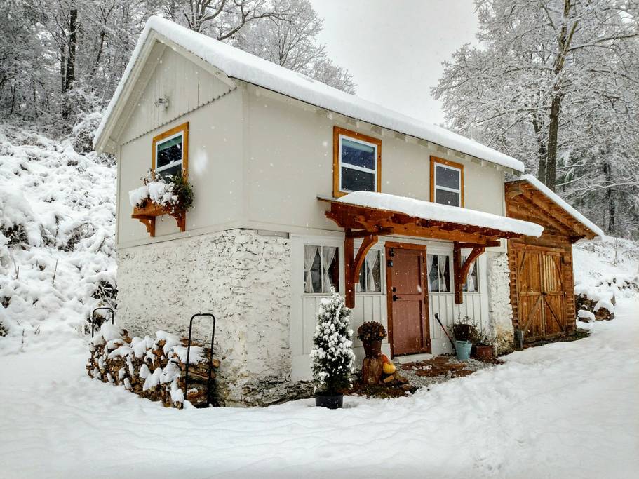 Snow falls outside of this idyllic coach house