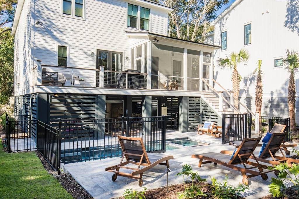 Gorgeous backyard featuring patio, deck, screened-in porch, under-the-house lounge, and in-ground pool