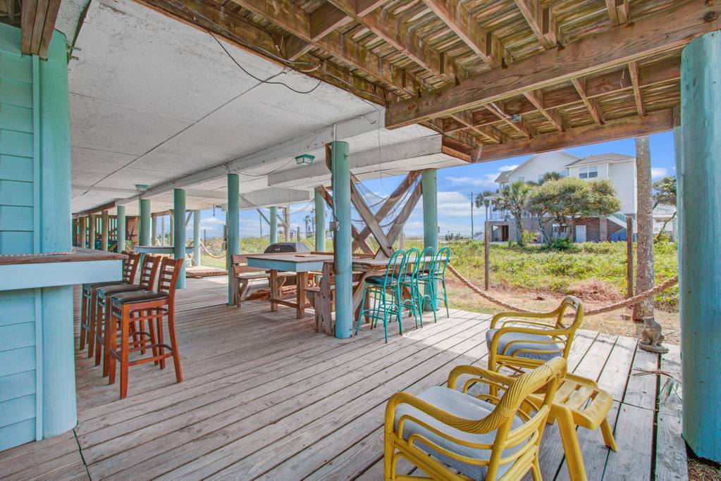 Hang out at the personal lounge of this rental featuring a private bar, picnic table, lounge chairs, and a great view of the beach