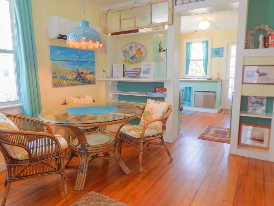 Vivid colors and patterns decorate the dining room in one of the three cottages from these Folly Beach vacation rentals