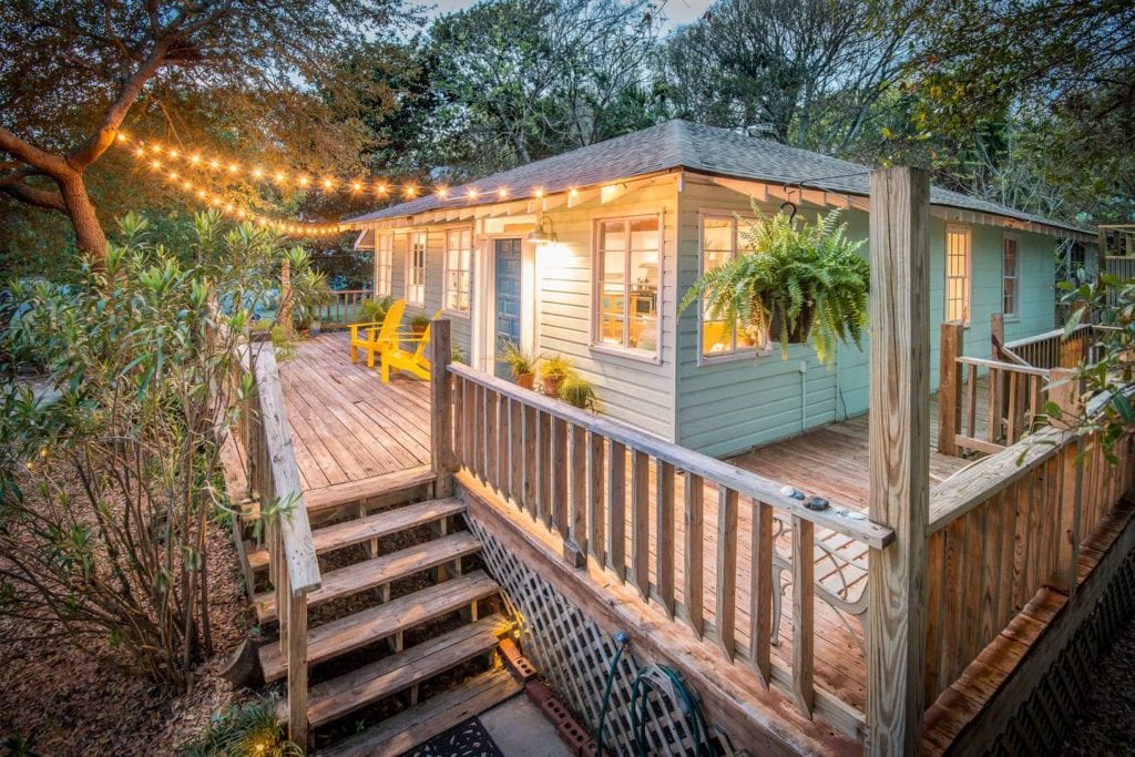 Deck of this bungalow is lit by string lights; a better alternative to Folly Beach hotels