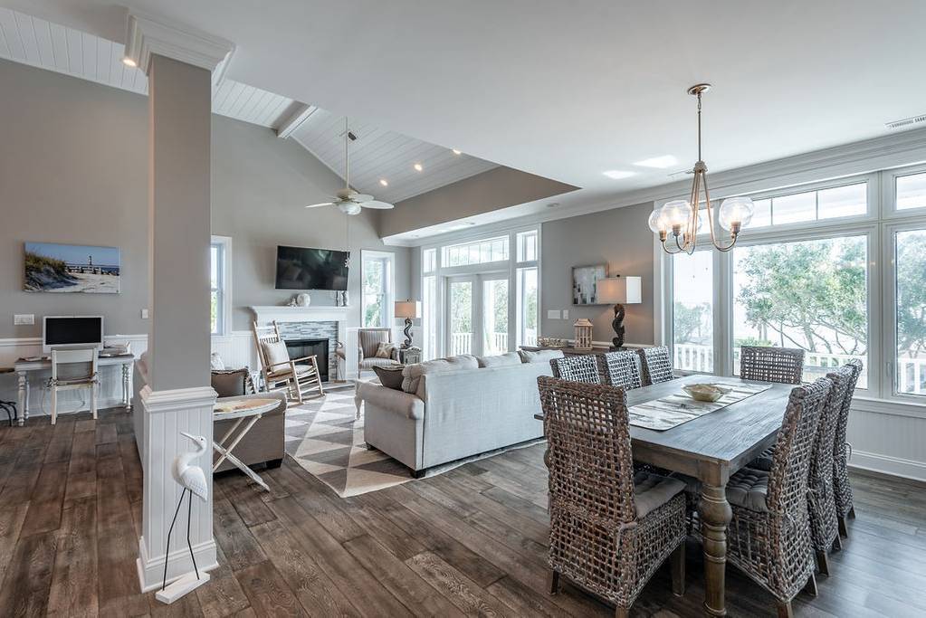 French doors from this living and dining room open up to a lovely back porch overlooking the ocean