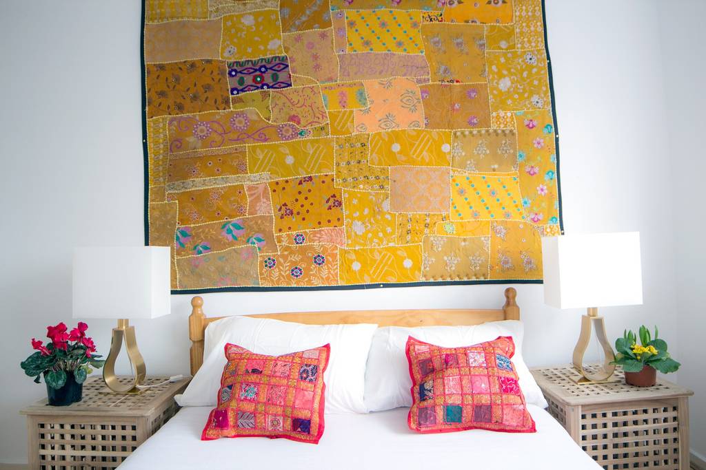 a London Airbnb with patchwork quilts above the bed