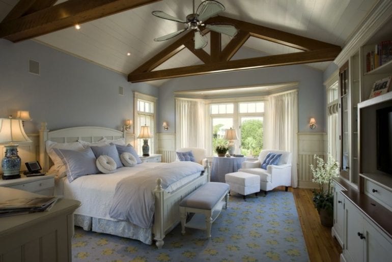 a bedroom with wooden beams in the ceiling 