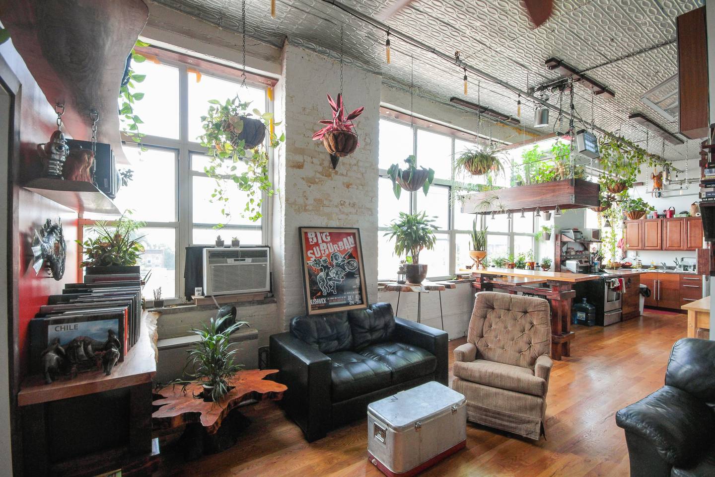 plant filled apartment with views of manhattan