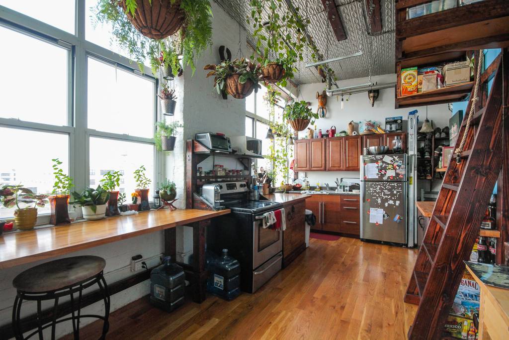 plant filled apartment with views of manhattan