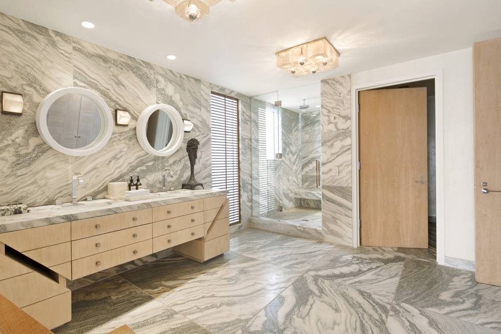 marble bathroom with light wooden paneling in a Los Angeles Airbnb