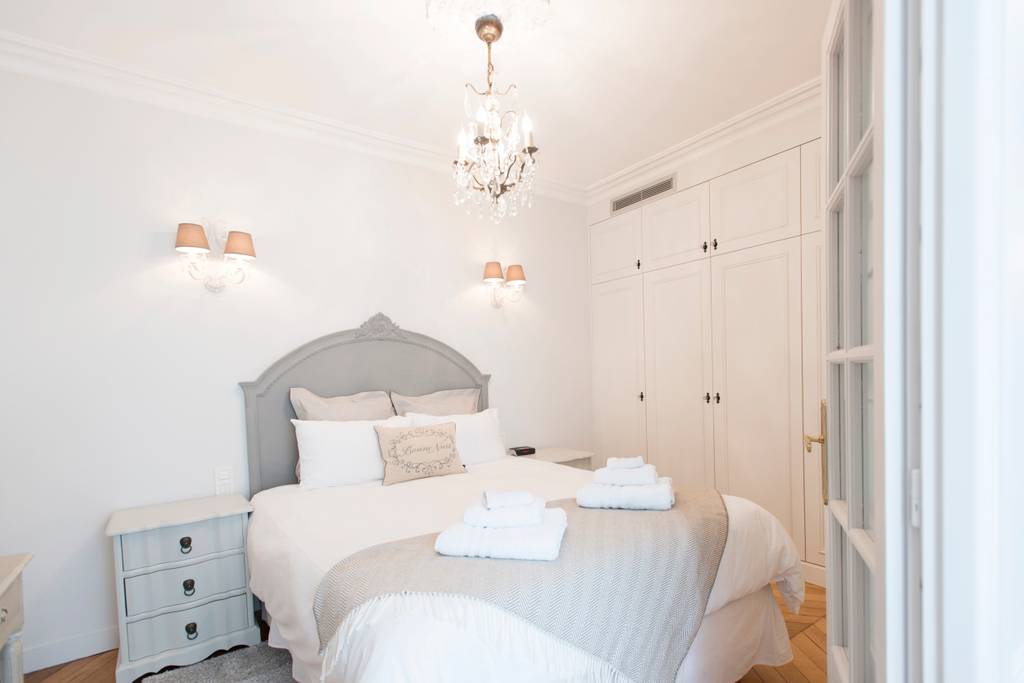 A bedroom with fresh towels in a romantic Paris Airbnb