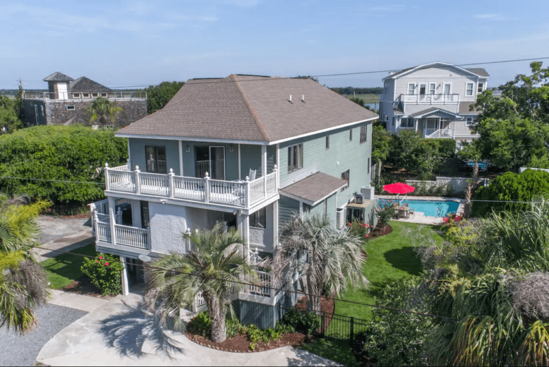 a turquoise 3 story home in Charleston