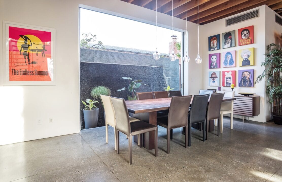 a concrete floored dining area with an endless summer poster in Los Angeles