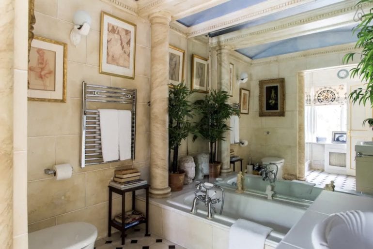 a bathroom with marble pillars in Kensington, London