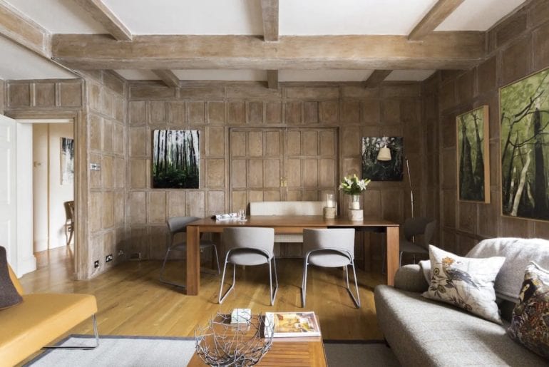 wood panelled walls and a scandinavian style dining table in a trafalgar square airbnb