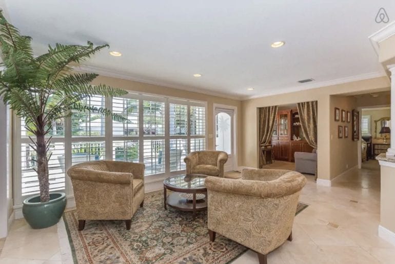 three armchairs on a rug in a West Palm Beach Airbnb property