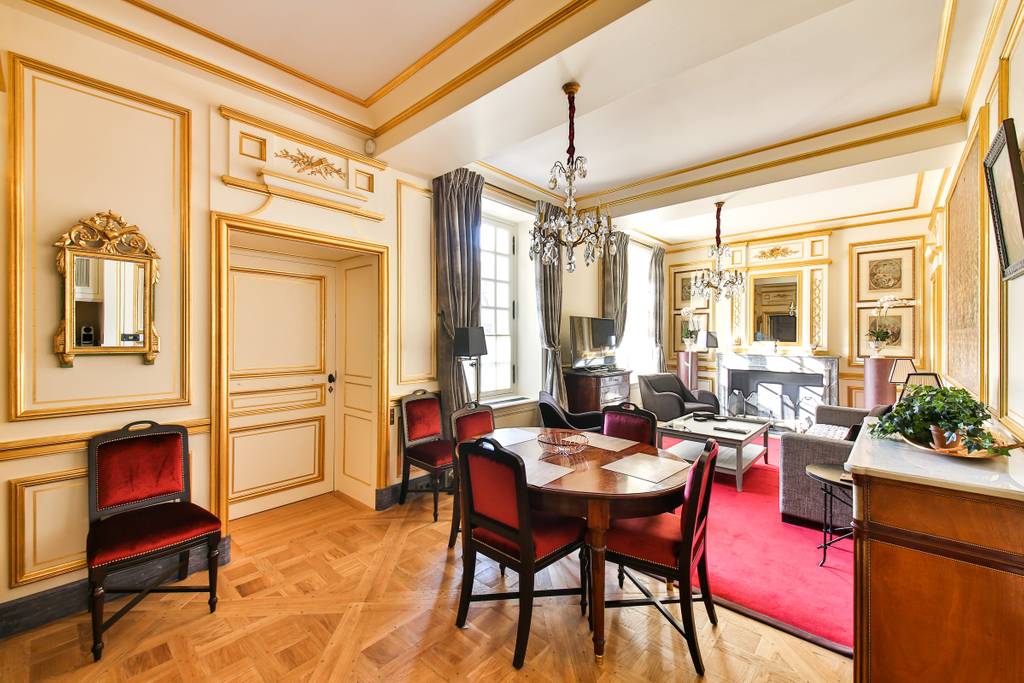 a gorgeous living area with gold paneling in Paris