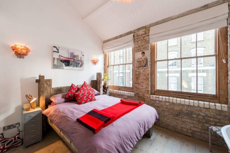 bedroom with bare brick walls in London Airbnb