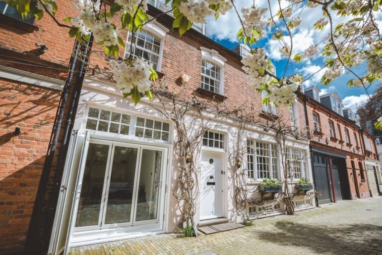 the outside of a Chelsea townhouse with vines growing up it