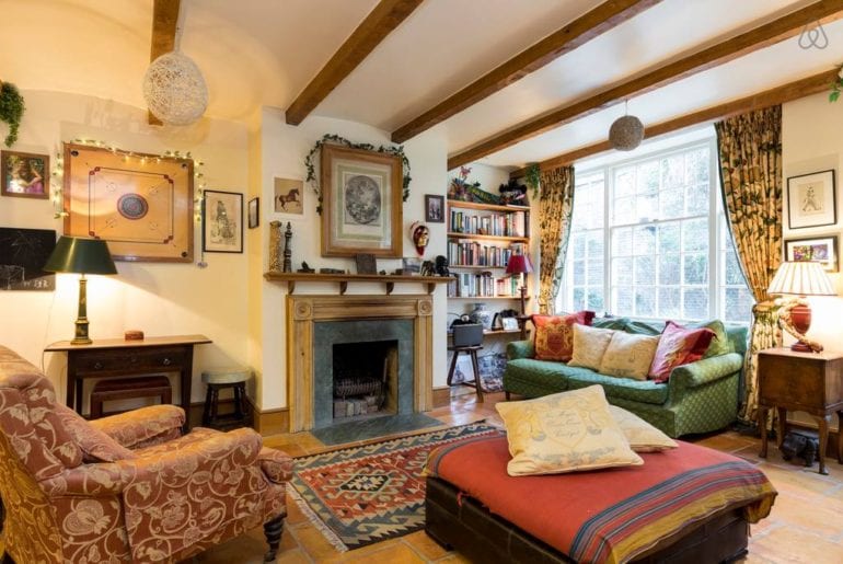 a living space with wood beams and comfortable looking furniture