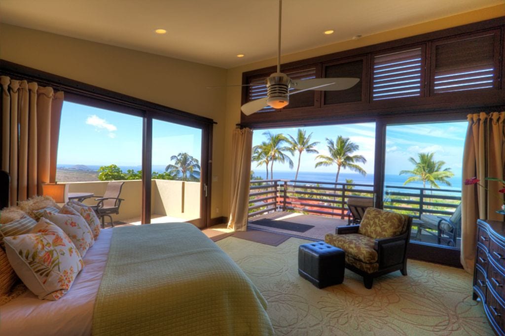 a view of palm trees from the bedroom