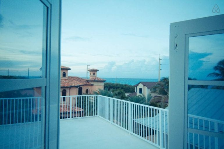 the view out of a window of some Spanish-style houses from an Airbnb in West Palm Beach