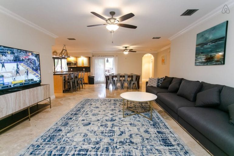 an expansive living room with a blue rug and blue sofa in West Palm Beach