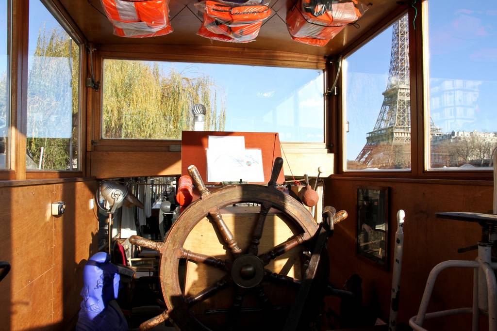 incredible houseboat docked in front of eiffel tower