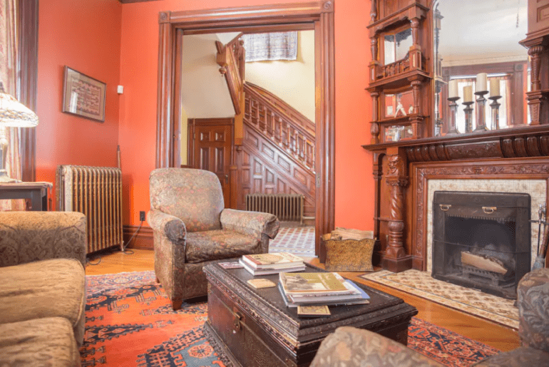 The living room has a cozy fireplace and plenty of seating